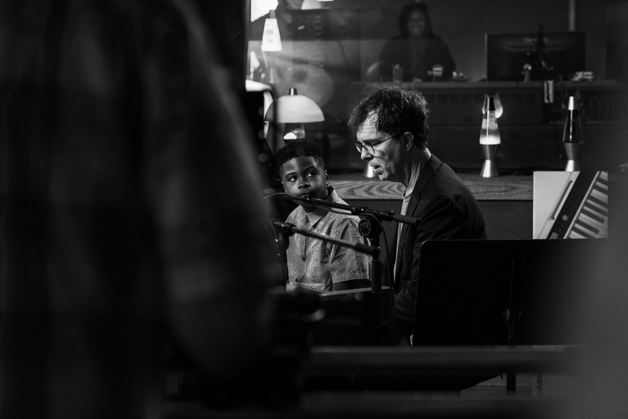 Ben Folds giving a piano lesson to a young boy.
