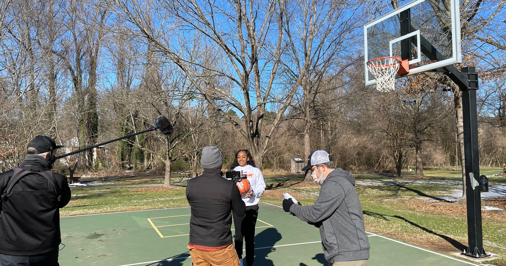 Deja Kelly being recorded for a video campaign on a basketball court