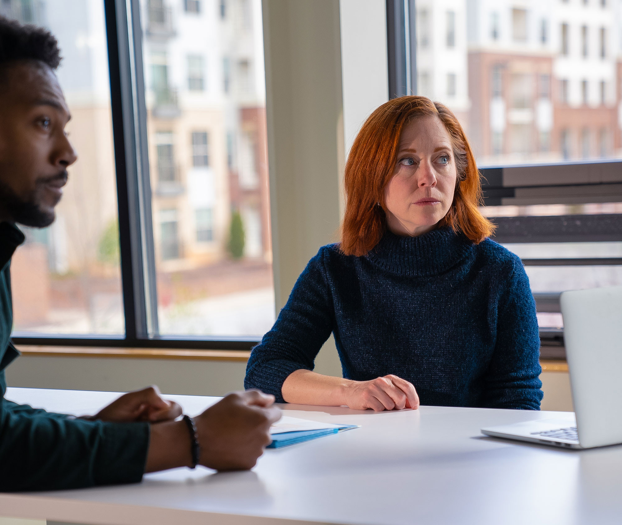 Two people sitting at a table during a meeting
