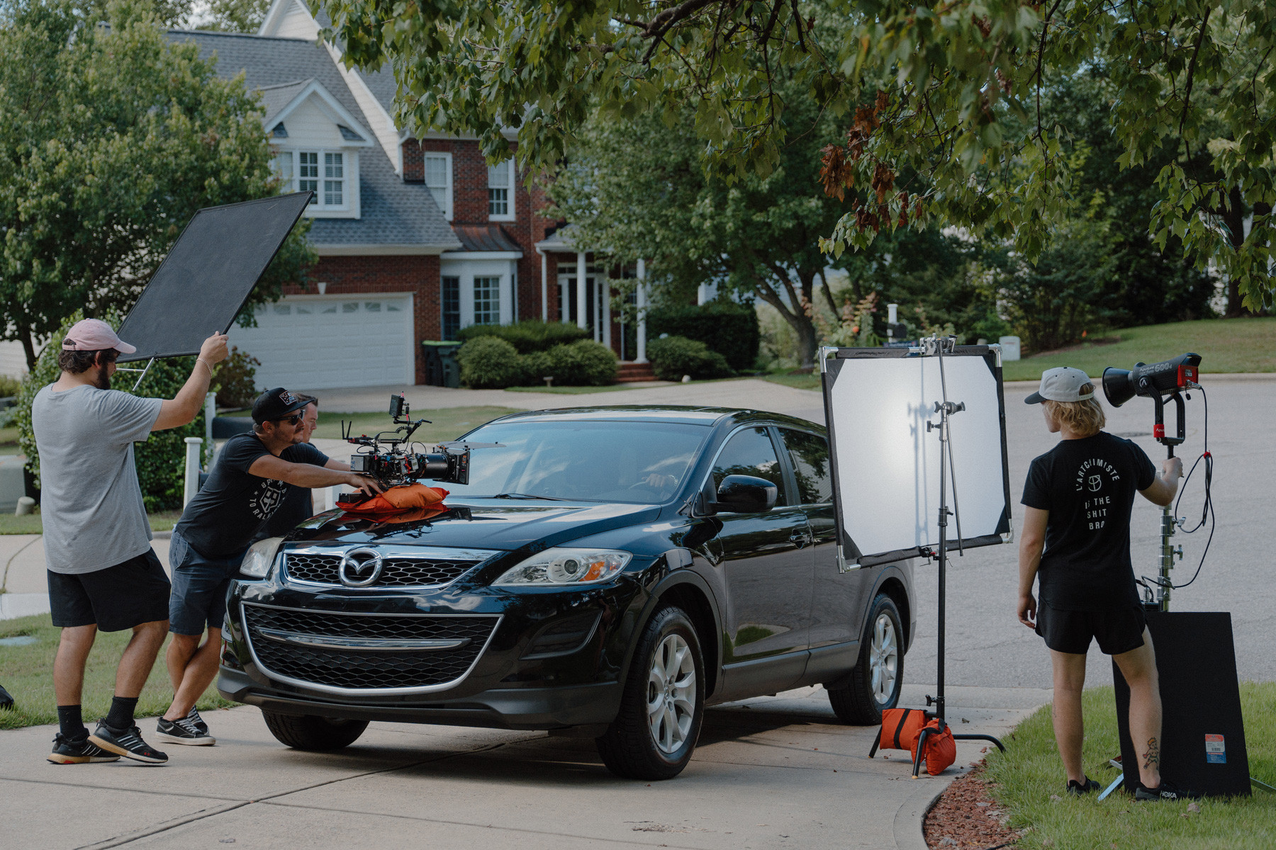 Film Crew filming outside of a car