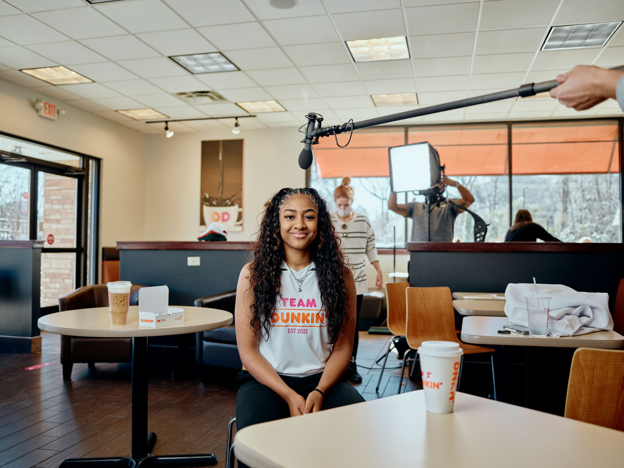 Basketball player Deja Kelly sitting in a Dunkin’.