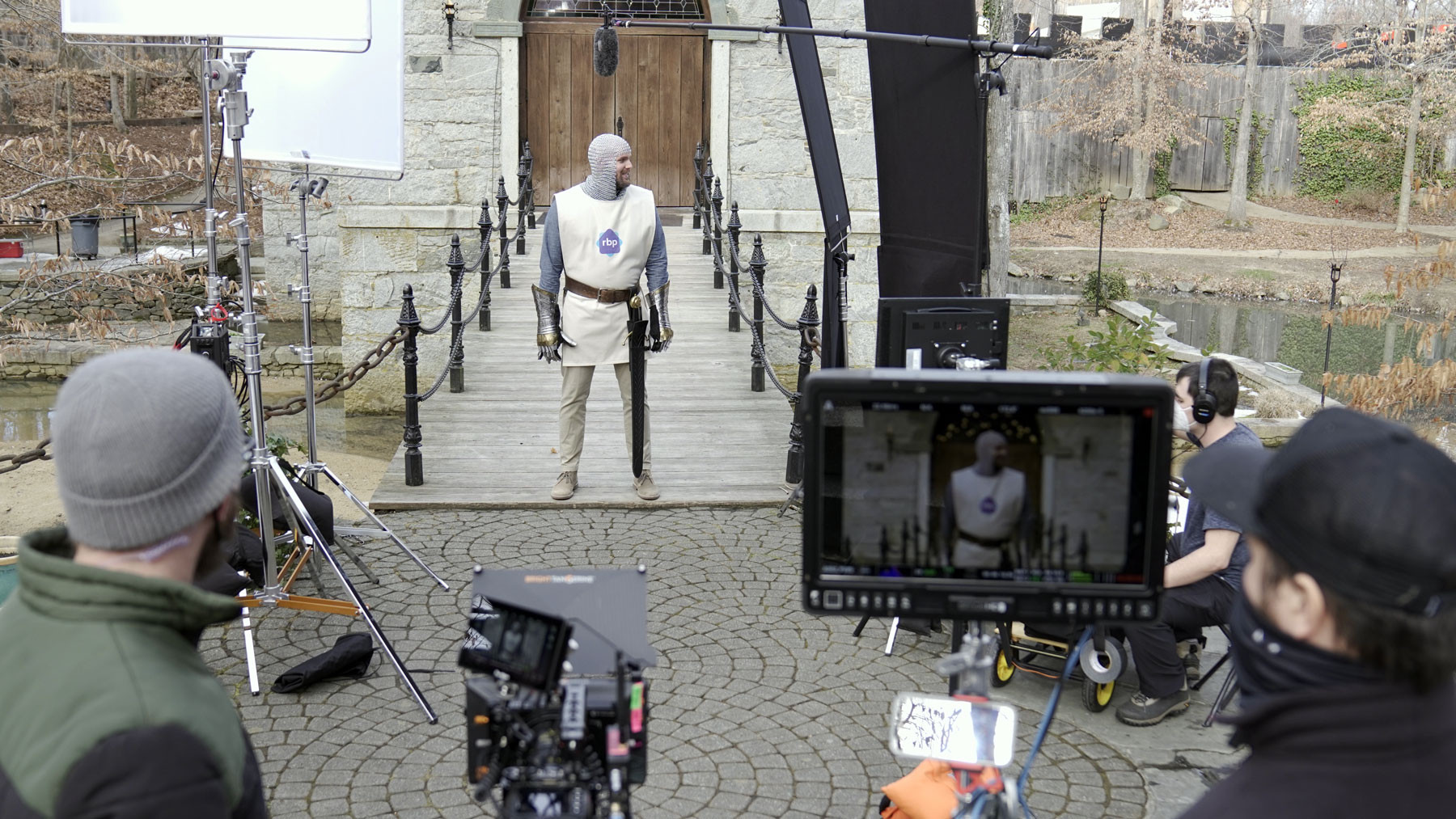 The crew shooting a scene in front of a medieval bridge