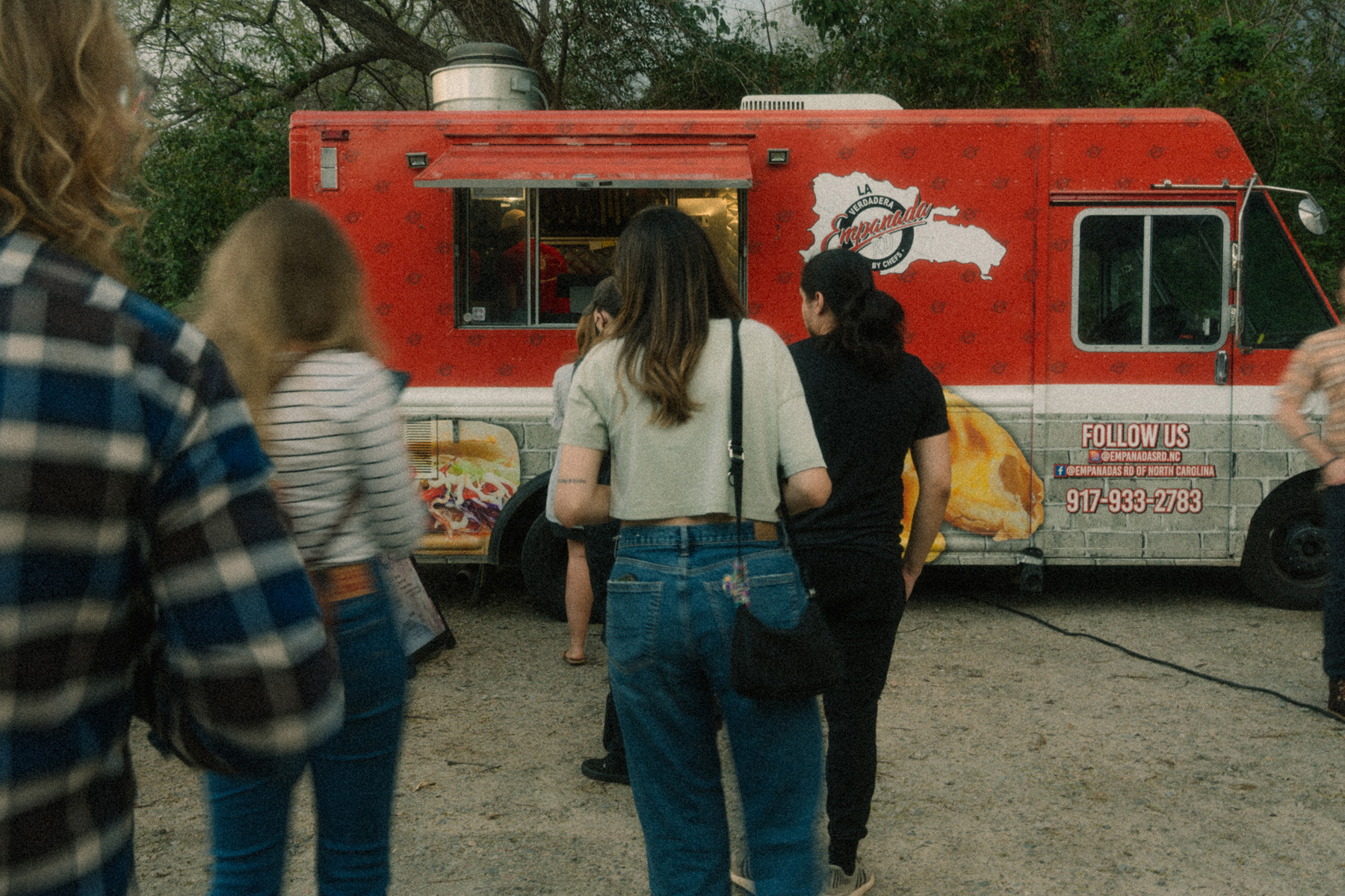 A group approaching a food truck.