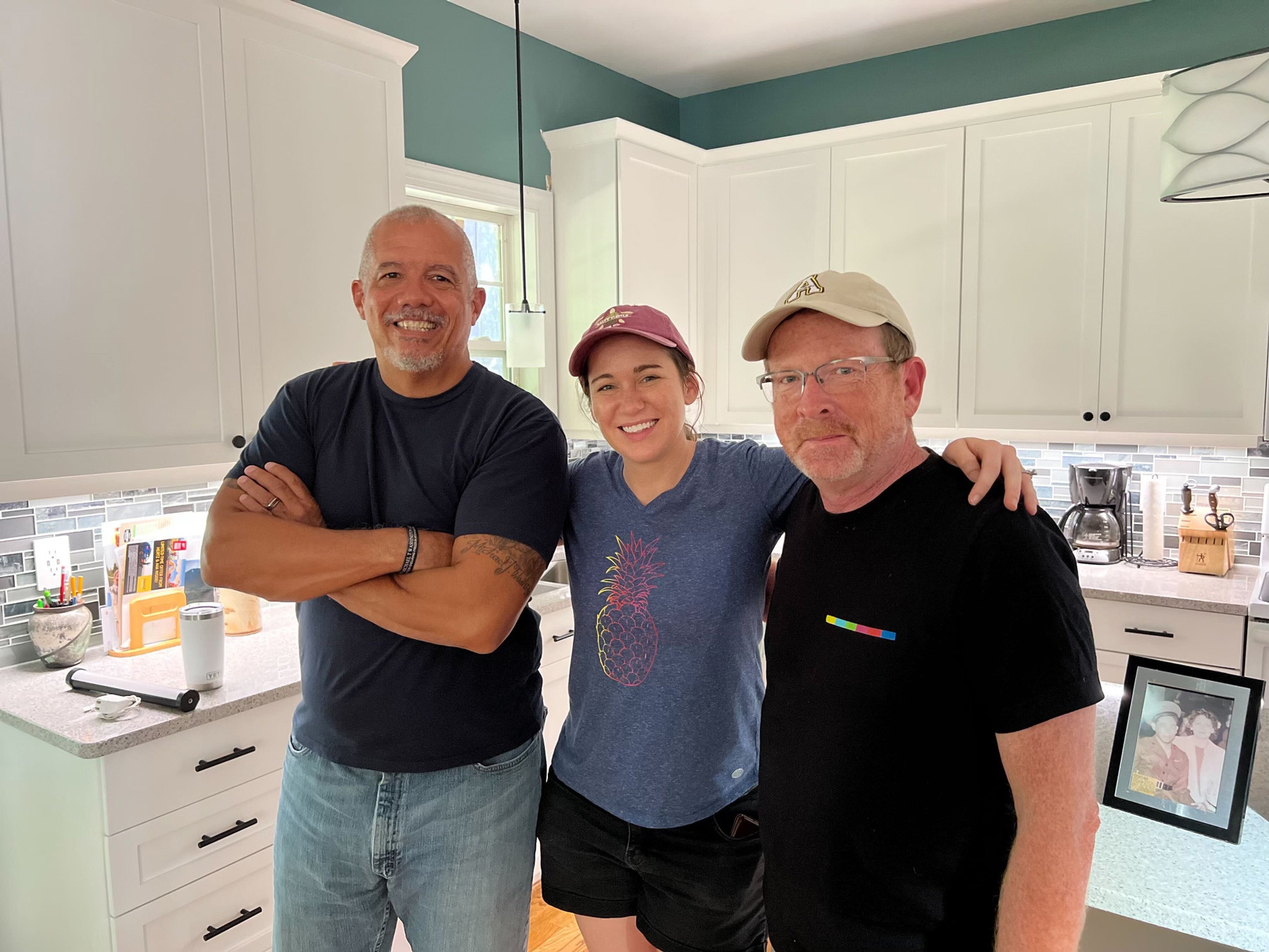 Three members of the film crew smiling 