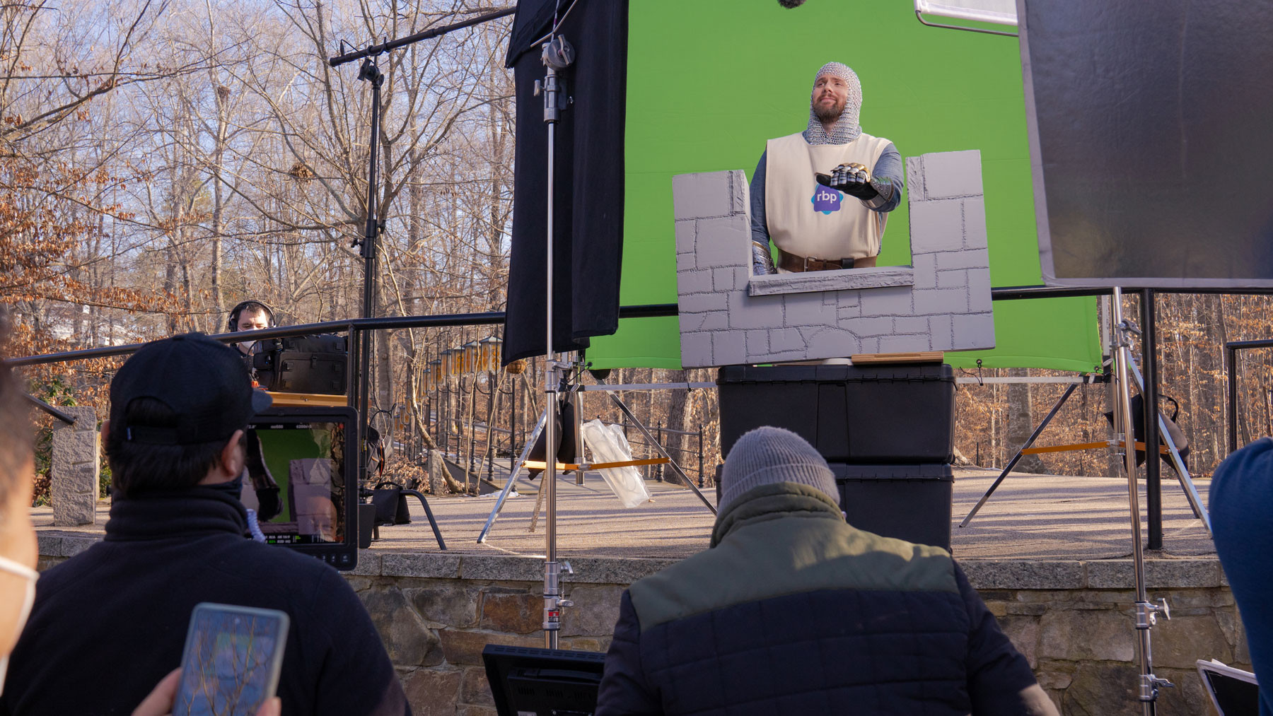Lance standing in front of a green screen