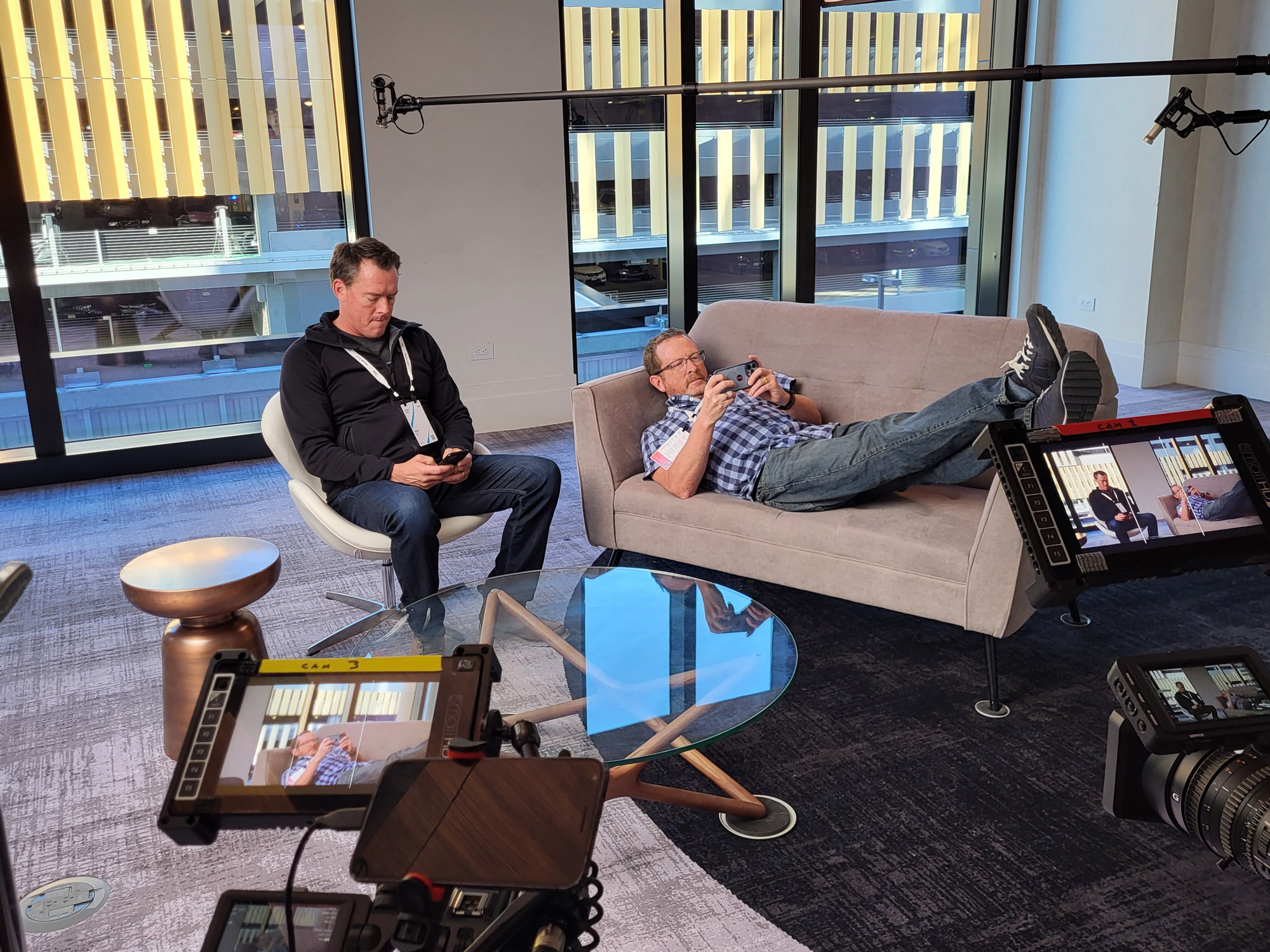 Filming a video of two men using their phones at the IBM Think conference