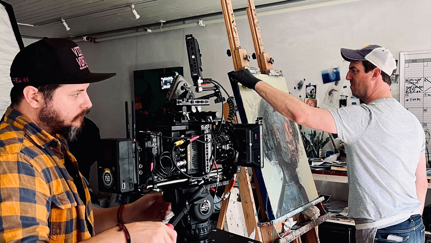 Myriad filming an artist working on an original painting. 